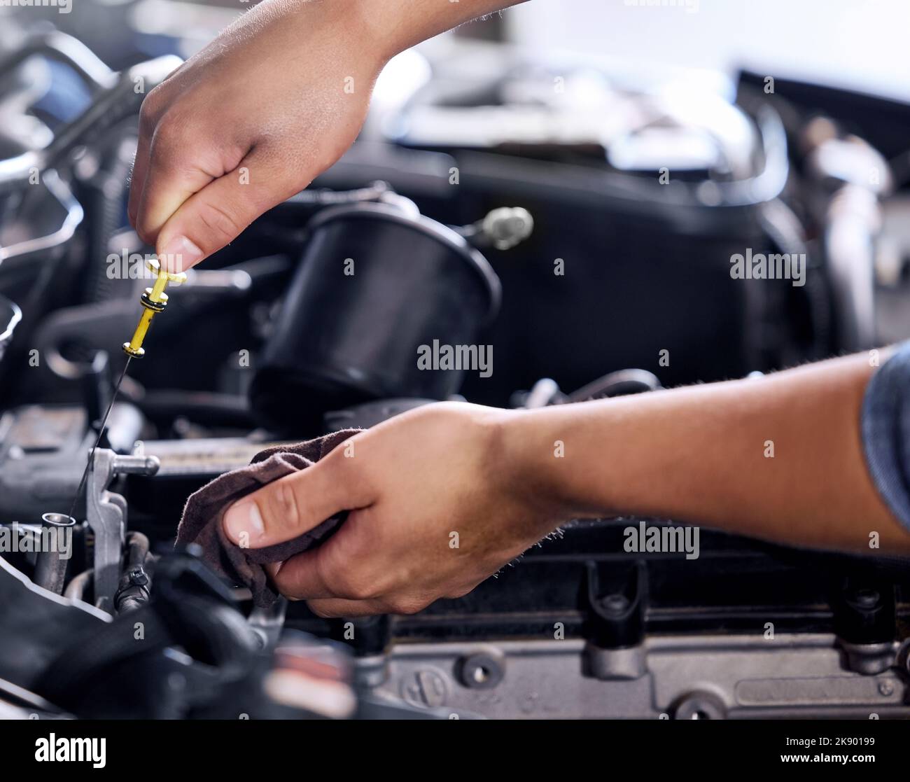 Closeup, car and engineer with tools for maintenance, repair and fixing in workshop at job. Hands, mechanic or working on motor, engine or vehicle in Stock Photo