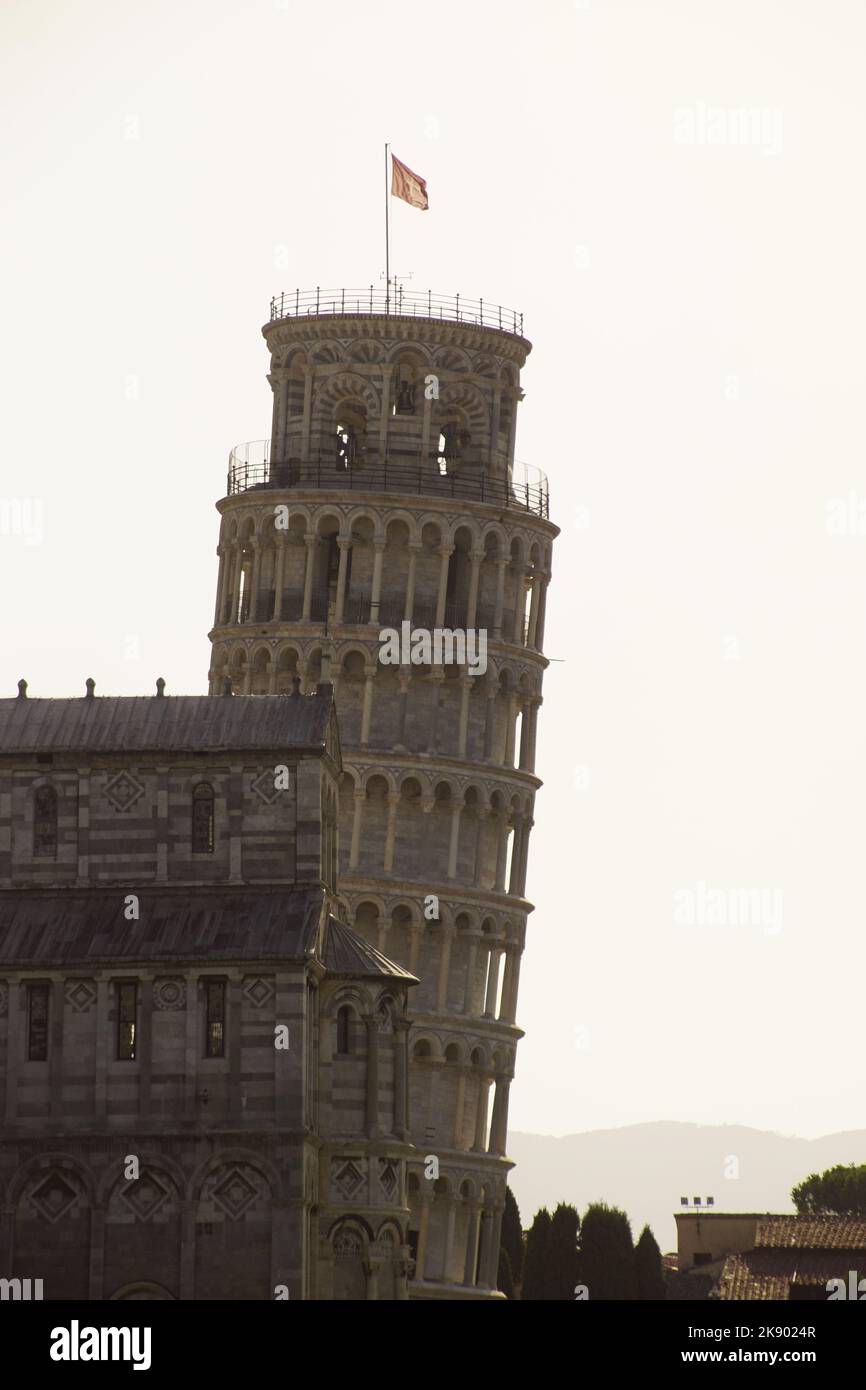 the Leaning Tower of Pisa faces the Cathedral. Mountains can be seen in ...