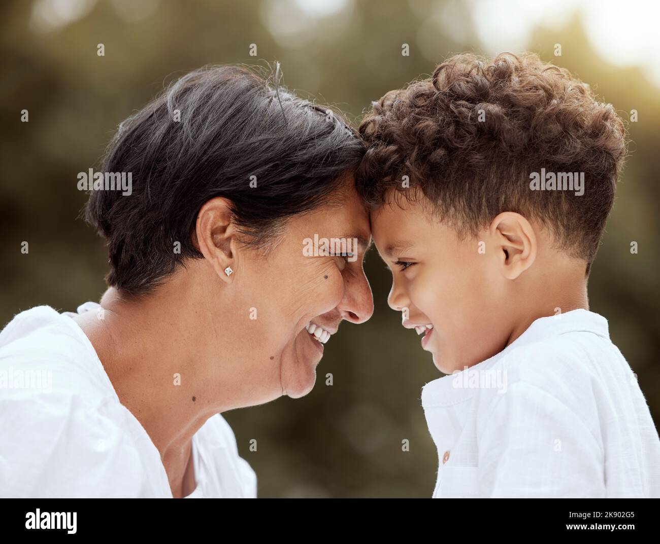 Love, family and grandmother with grandchild at park, relax and smile while bonding in nature together. Happy, smile and face of senior woman bonding Stock Photo