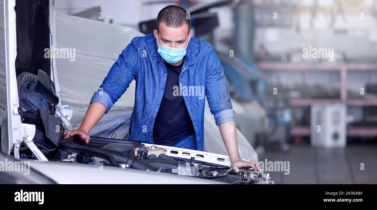 Mechanic, engine and car, man with face mask for covid safety at auto