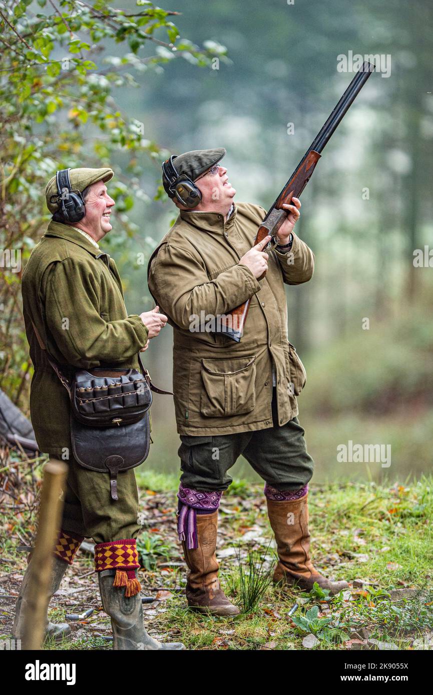 man shooting pheasants and his professional loader Stock Photo
