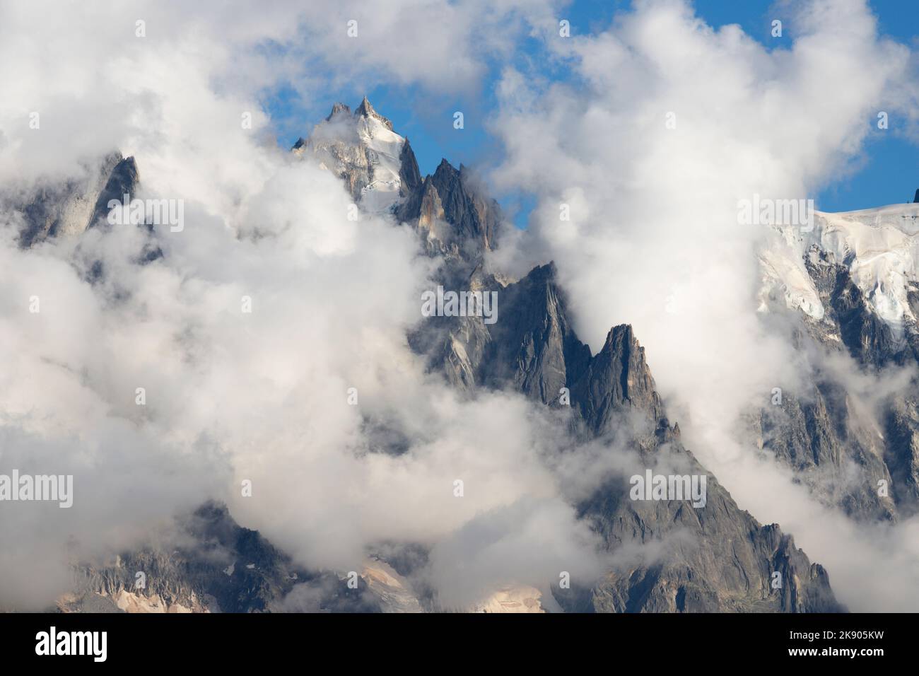 The peak Aiguille du Plan in the clouds - Chamonix - Mont Blanc massif. Stock Photo