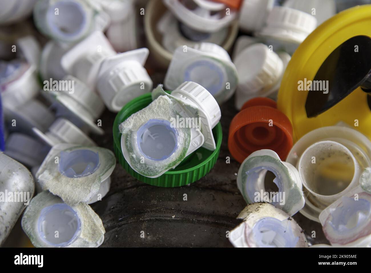 Dirty plastic caps in barrel, recycling and environment Stock Photo Alamy