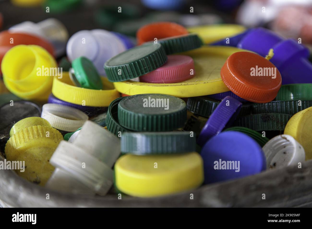 Dirty plastic caps in barrel, recycling and environment Stock Photo Alamy