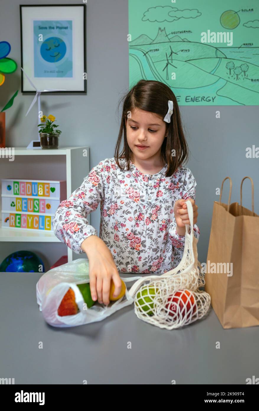 Student taking fruits from disposable plastic bag to reusable mesh bag