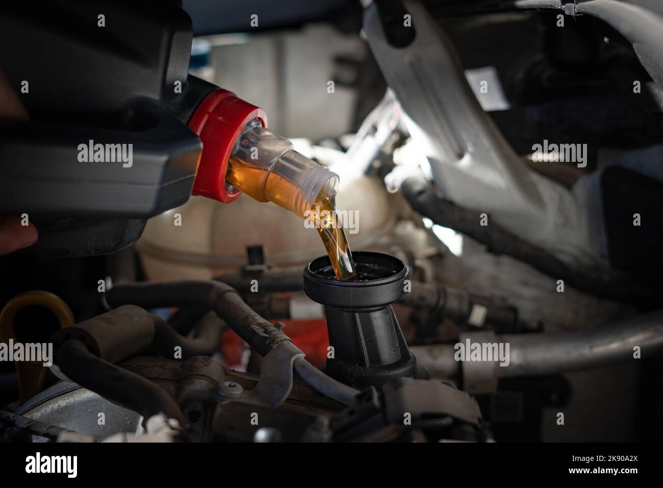 Engine oil is pouring into the engine Stock Photo Alamy