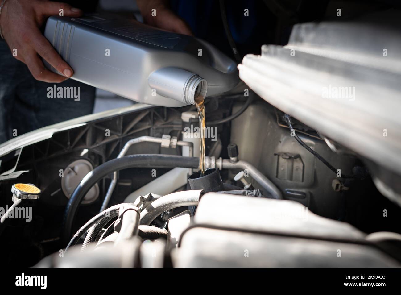 Engine oil is pouring into the engine Stock Photo Alamy