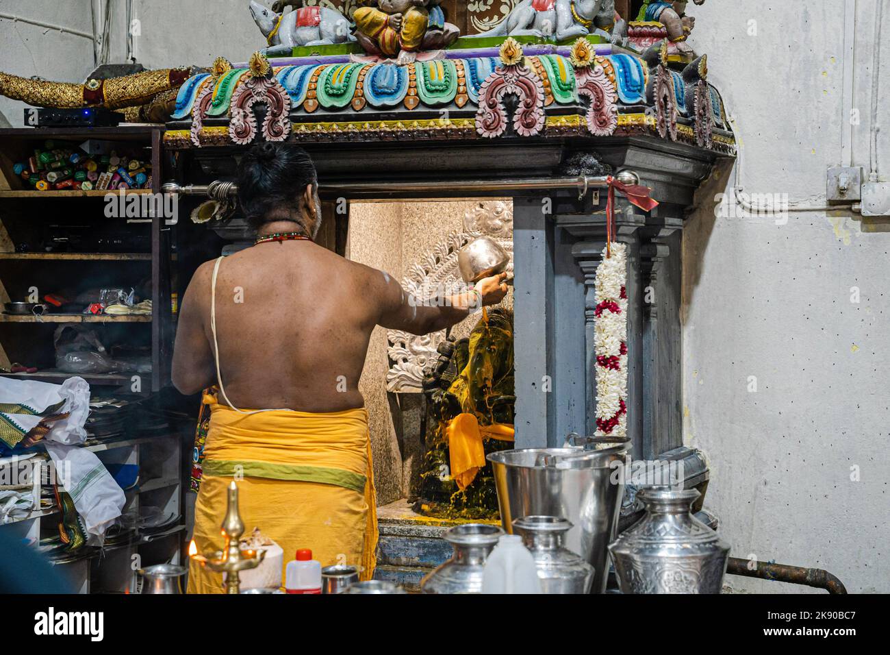 A pandit or Hindu priest performs Abhishekam puja, a Hindu ritual of ...