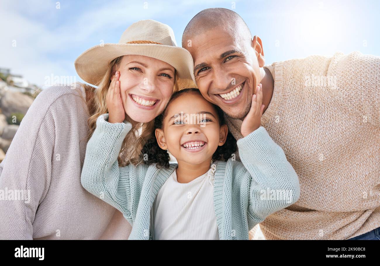 Family, smile and face portrait in nature on holiday, vacation or summer trip. Diversity, travel and parents, father and mother with girl, love and Stock Photo