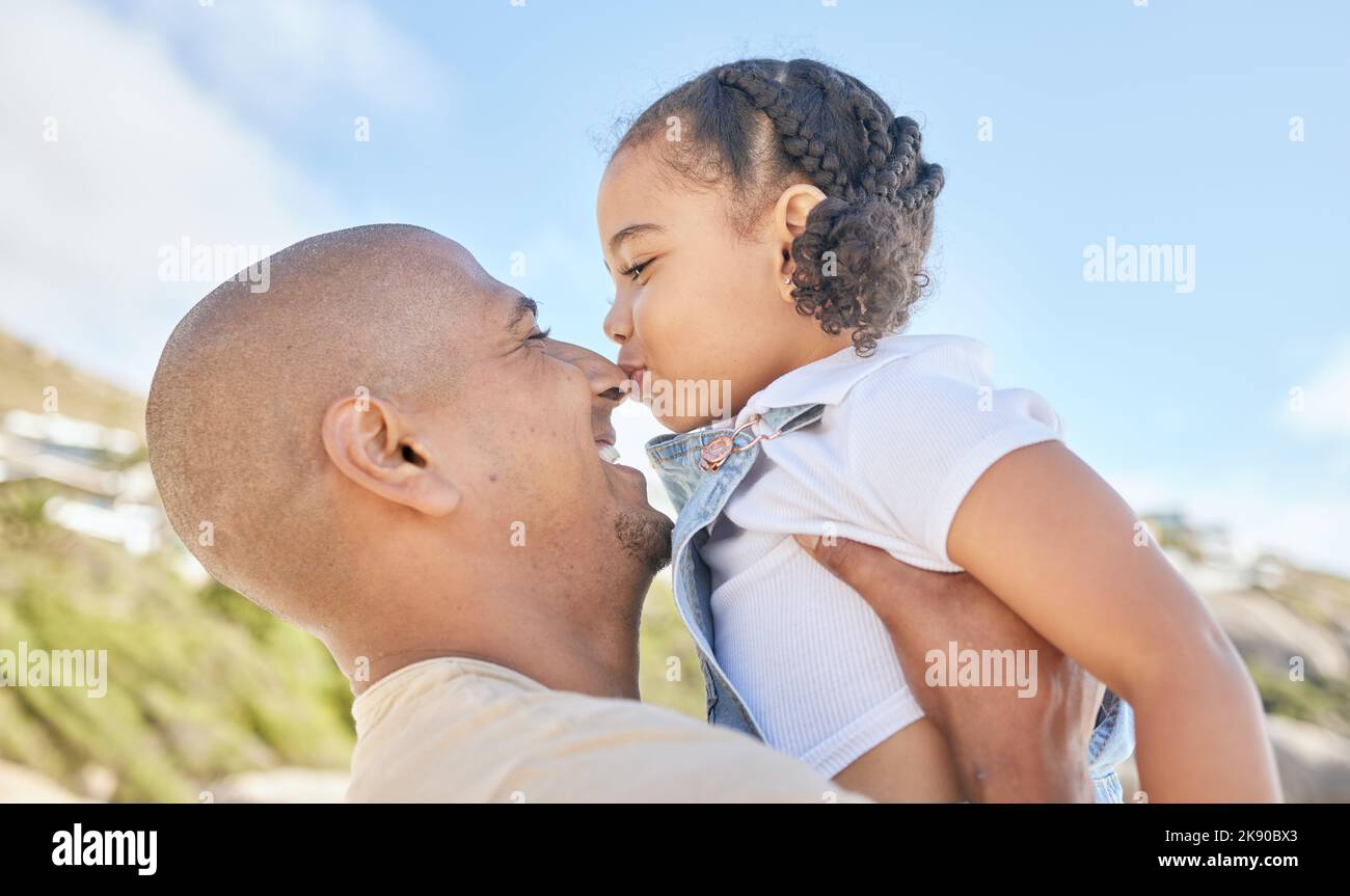 Father, child and nose kiss in nature for fun, love and relationship in family bonding time in the outdoors. Happy dad and kid enjoying summer Stock Photo