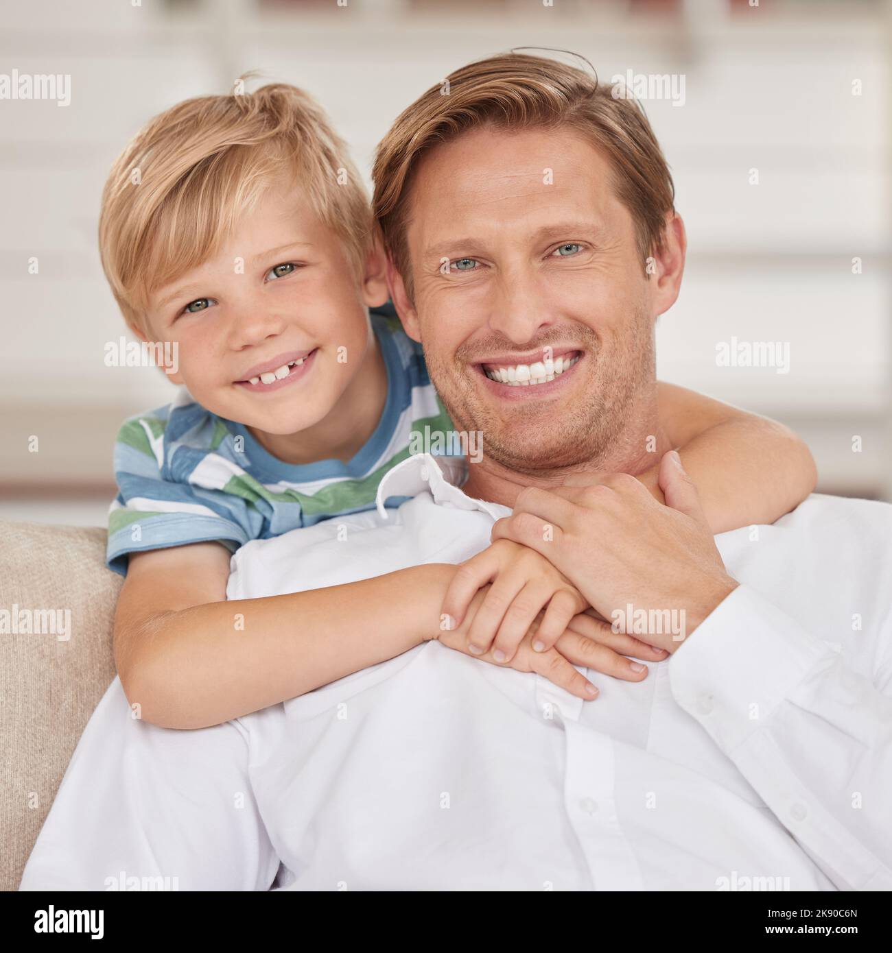 Family, love and portrait of father with son sitting on the sofa, smile of faces. Happiness, affection and child bonding with single dad in family Stock Photo