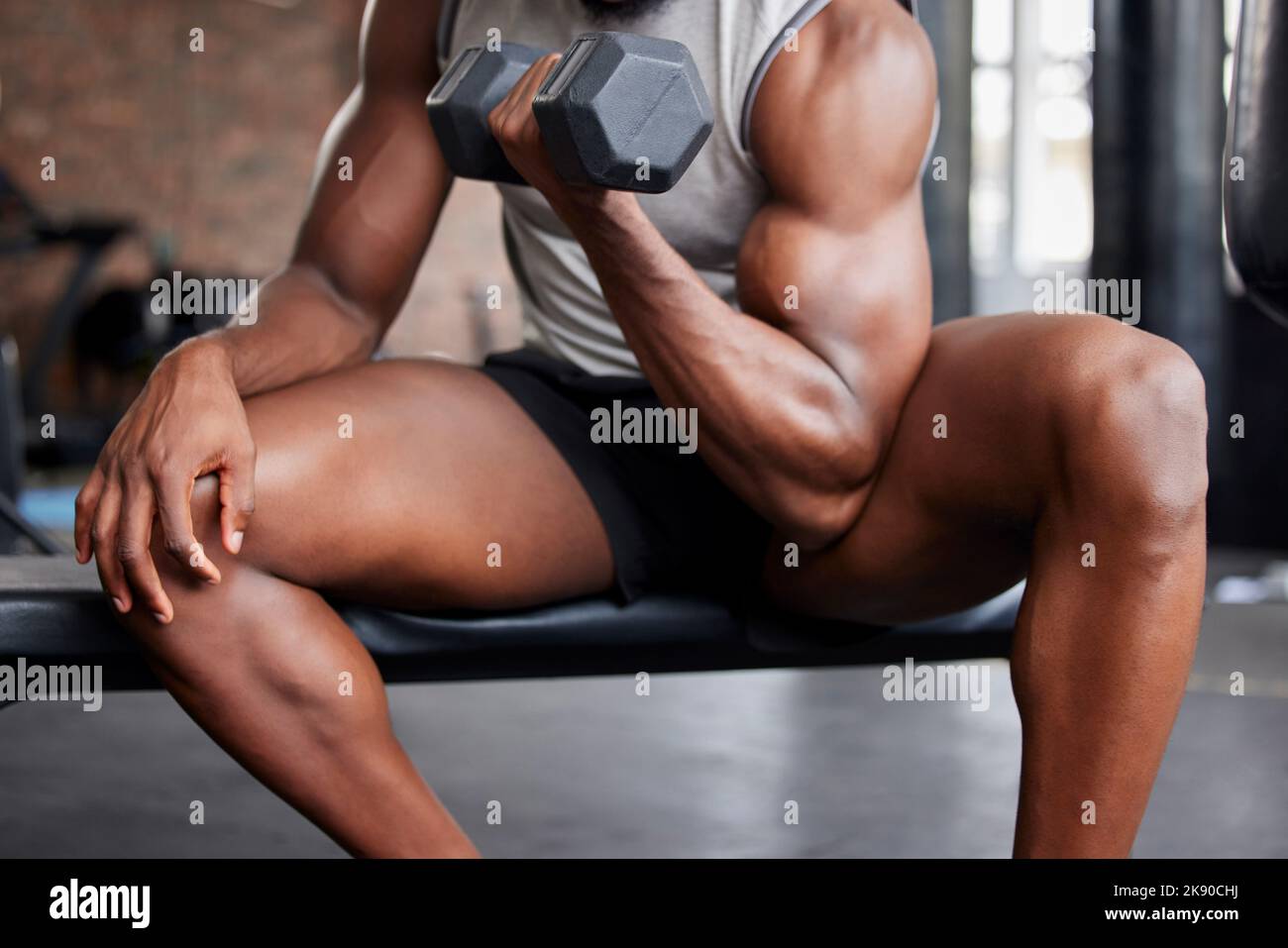 Gym man, exercise and biceps training with dumbell for weightlifting, fitness and bodybuilding at sports center. Power, muscle and guy bodybuilder arm Stock Photo