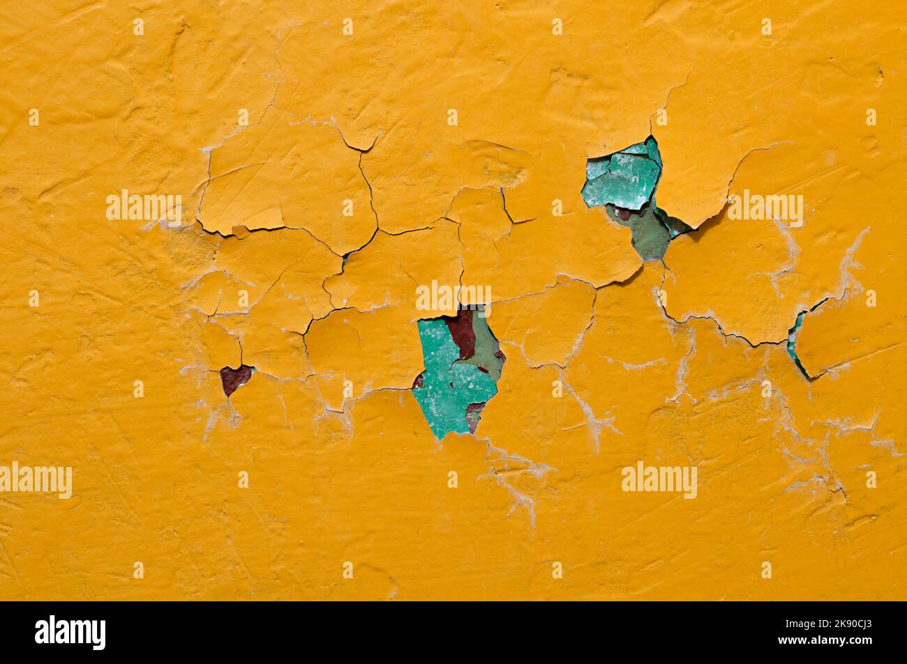 Yellow peeling paint on the concrete surface, peeling paint background, texture of peeling paint Stock Photo