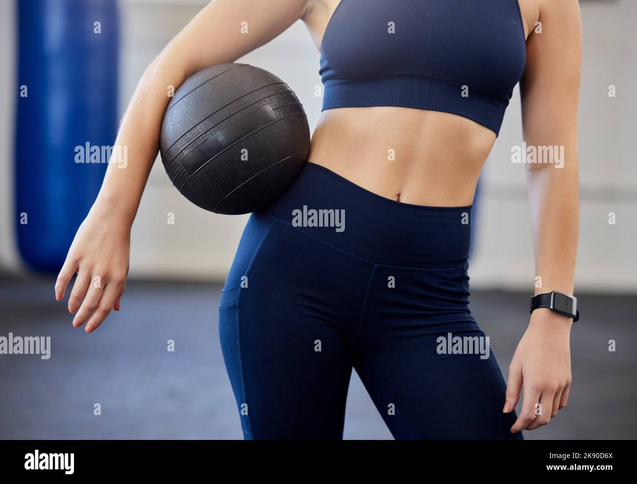 Woman, fitness and medicine ball for exercise, workout or training in a gym for a healthy, wellness and strong body. Athlete with equipment or gear Stock Photo