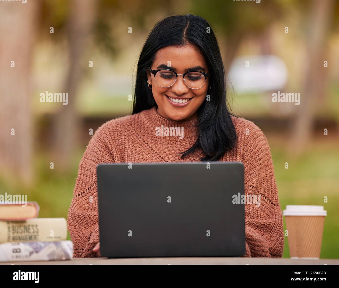 University, laptop and student studying on campus outdoor research