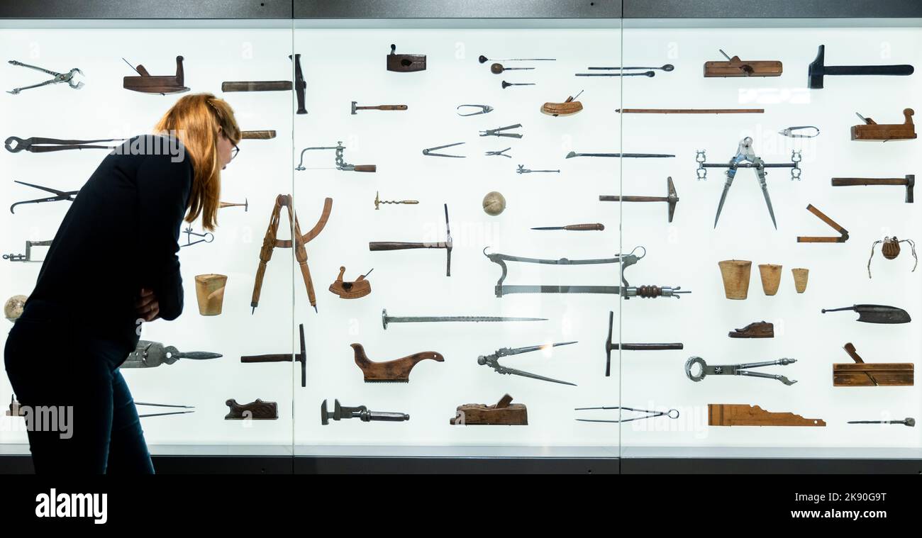 Nuremberg, Germany. 25th Oct, 2022. Historical handicraft tools (16th to 19th centuries) hang in a display case in the new section of the permanent exhibition 'Handicrafts and Medicine 1500-1900' at the Germanisches Nationalmuseum. From October 27, 2022, visitors will be able to view handicraft devices and medical instruments from the early 16th century to the end of the 19th century there again. Credit: Daniel Karmann/dpa/Alamy Live News Stock Photo