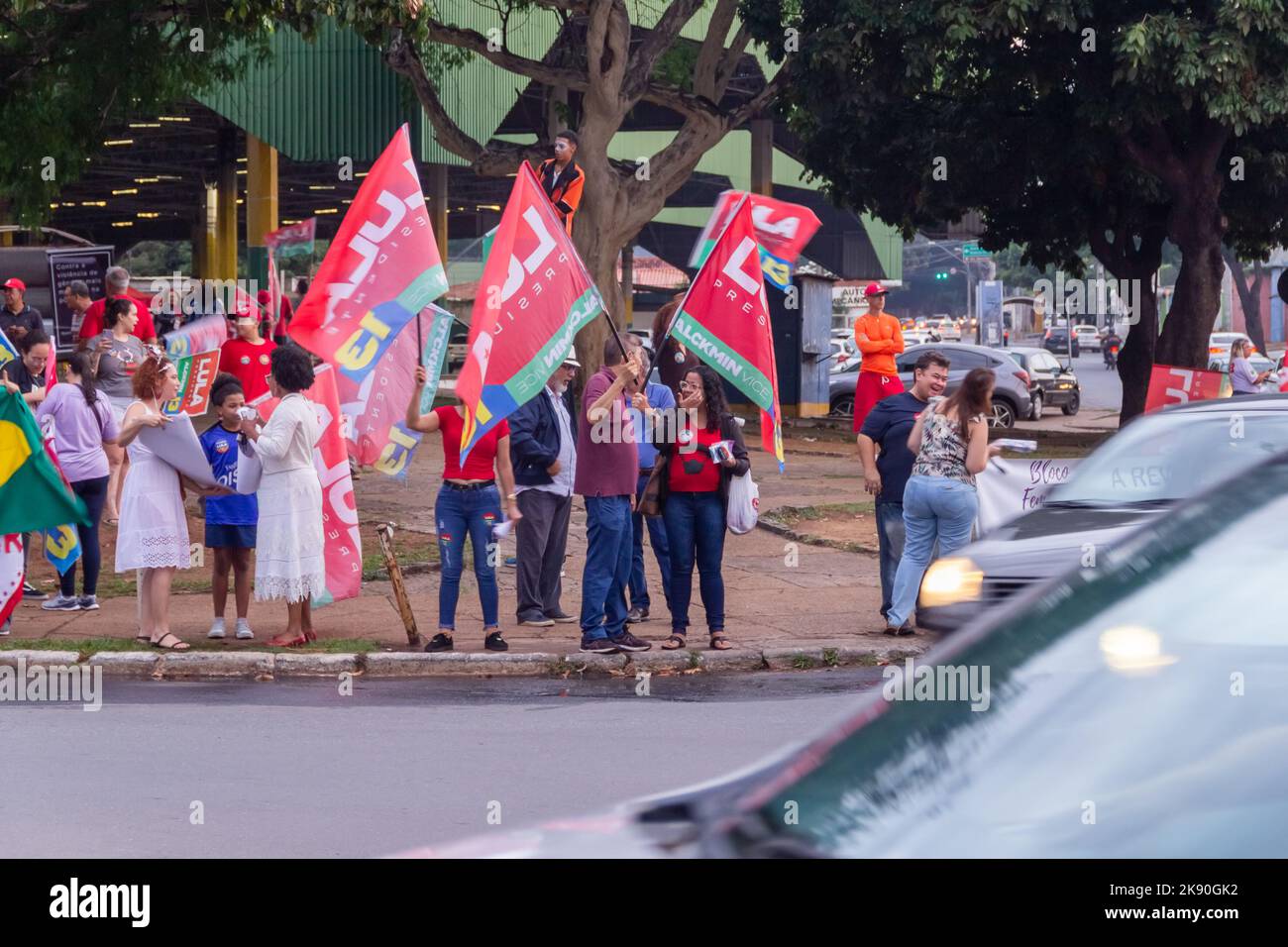 Goiânia, Goias, Brazil – October 21, 2022: Several people in action on the street with Lula's red flags. Image made in an act to ask for votes for Lul Stock Photo