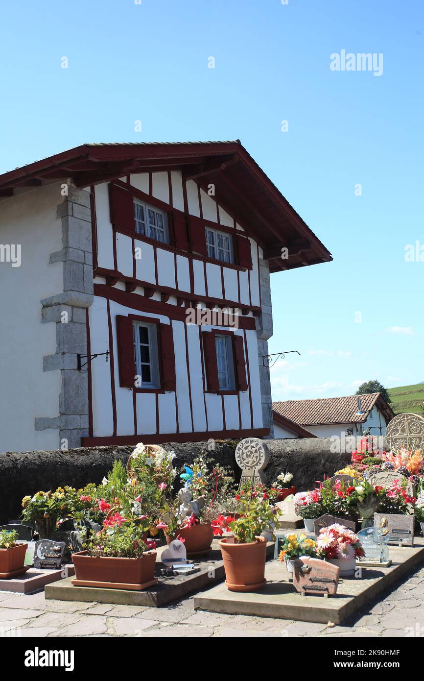 Typical Basque cemetery and village house in the pretty village of Ainhoa, Pyrenees Atlantiques, France Stock Photo