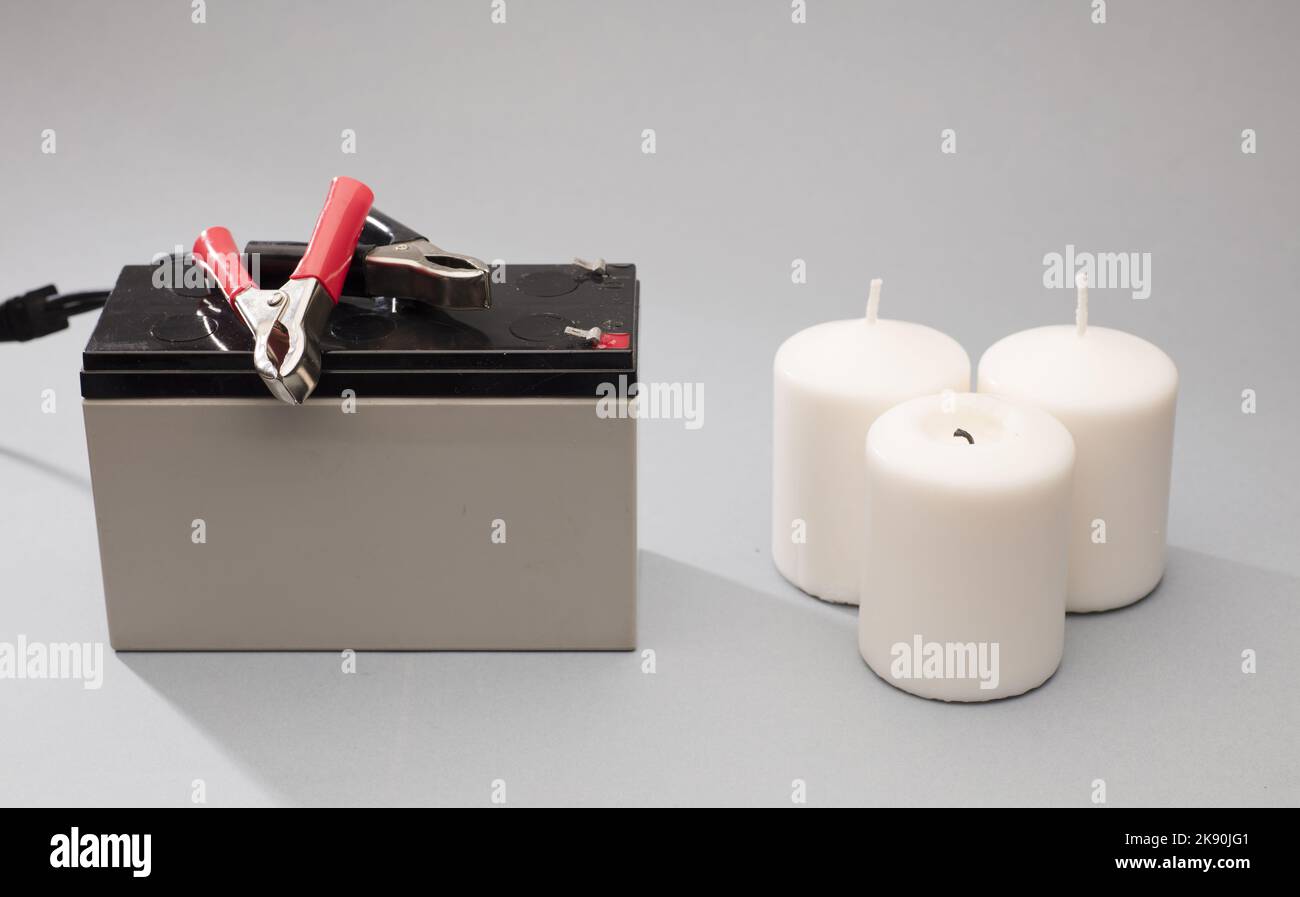 12v battery, positive red bolts, negative black, gray candle background Stock Photo Alamy