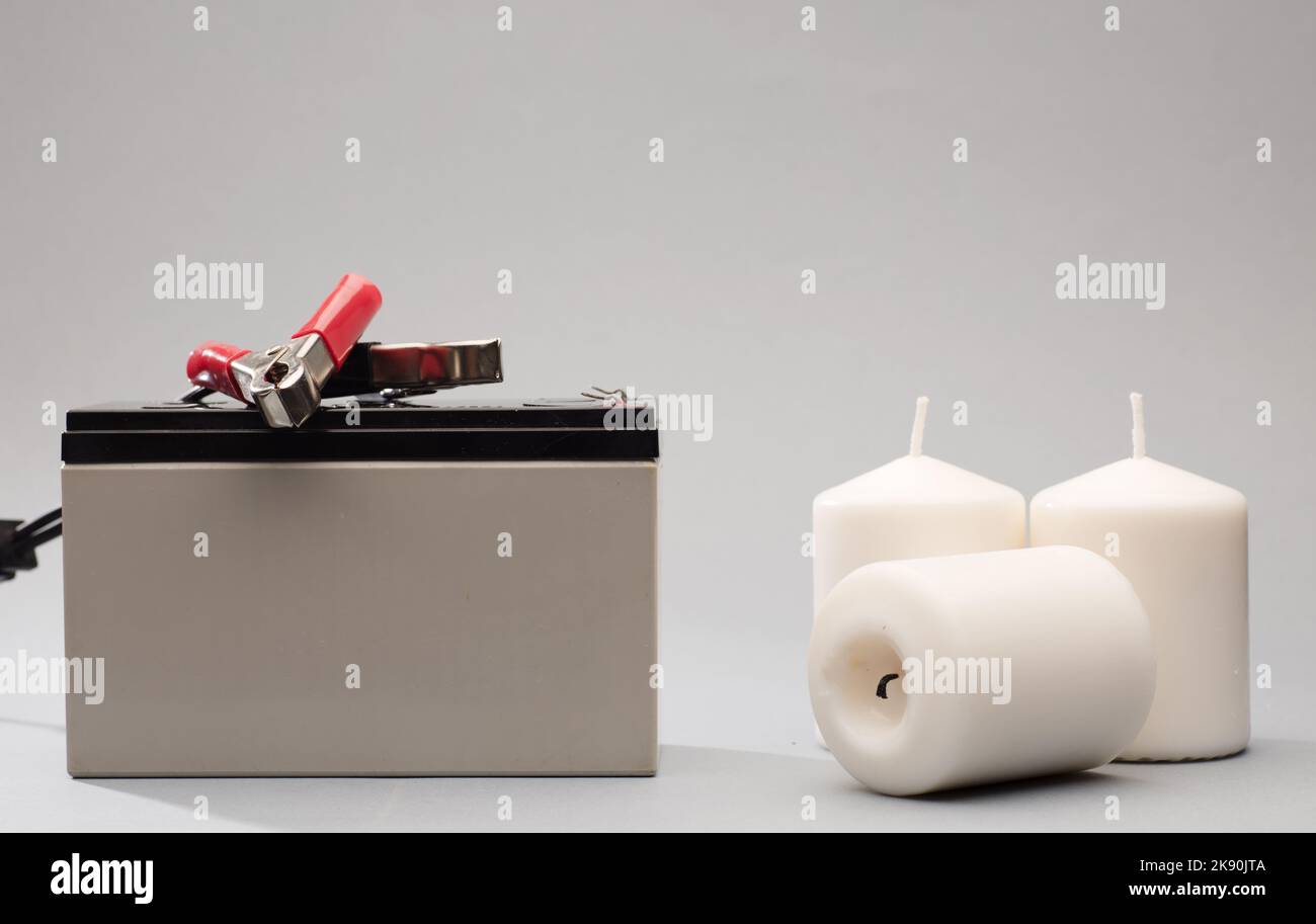 12v battery, positive red bolts, negative black, gray candle background Stock Photo Alamy