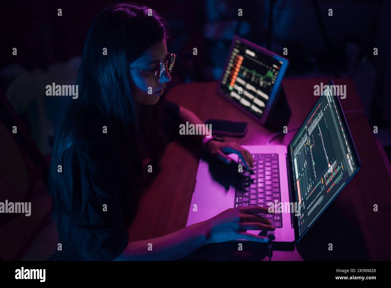 Attractive young woman working in home at night Stock Photo - Alamy