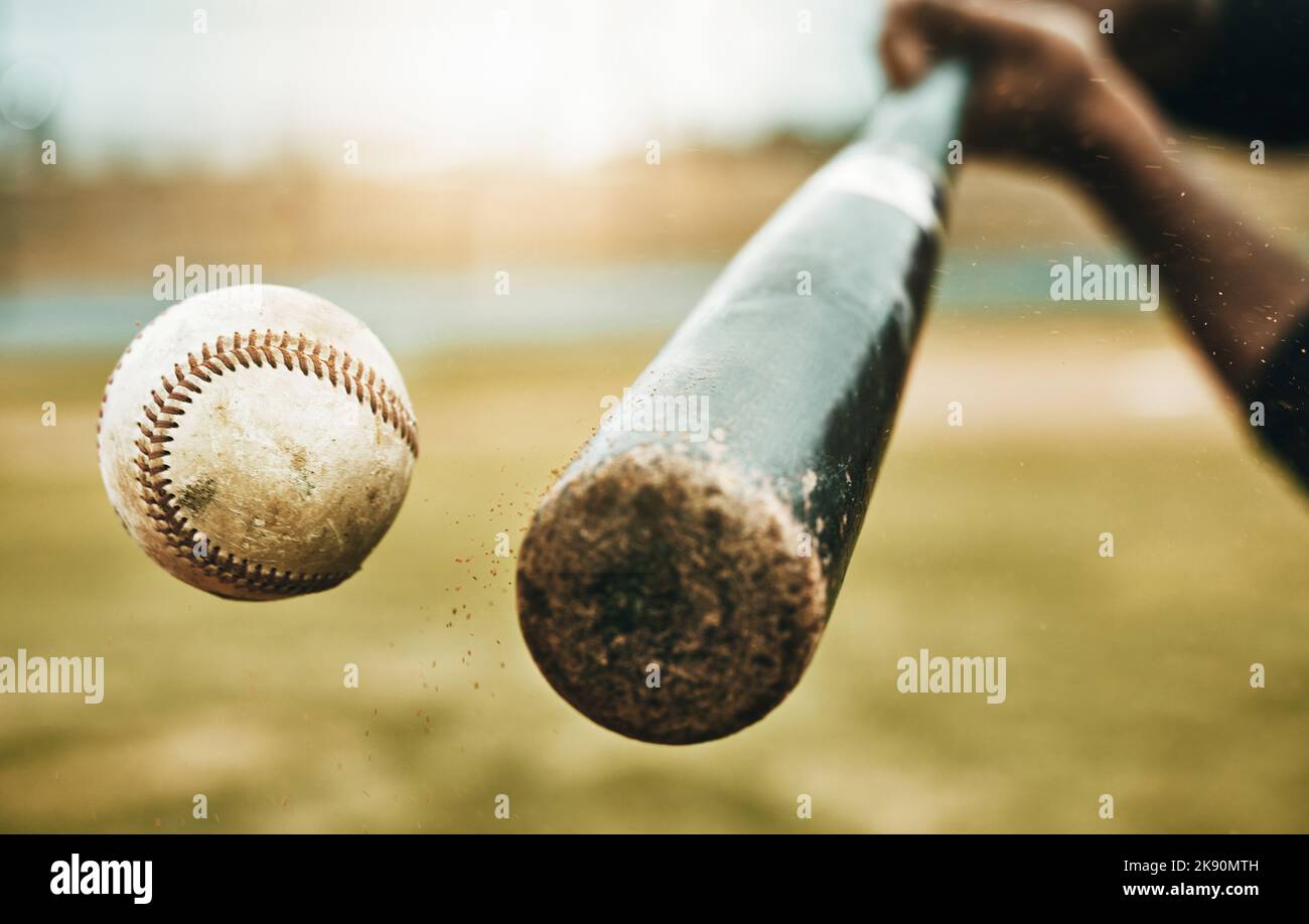 Baseball hit, sports and athlete on a outdoor field hitting a ball in a game with a baseball bat. Sport, baseball player and man busy with exercise Stock Photo