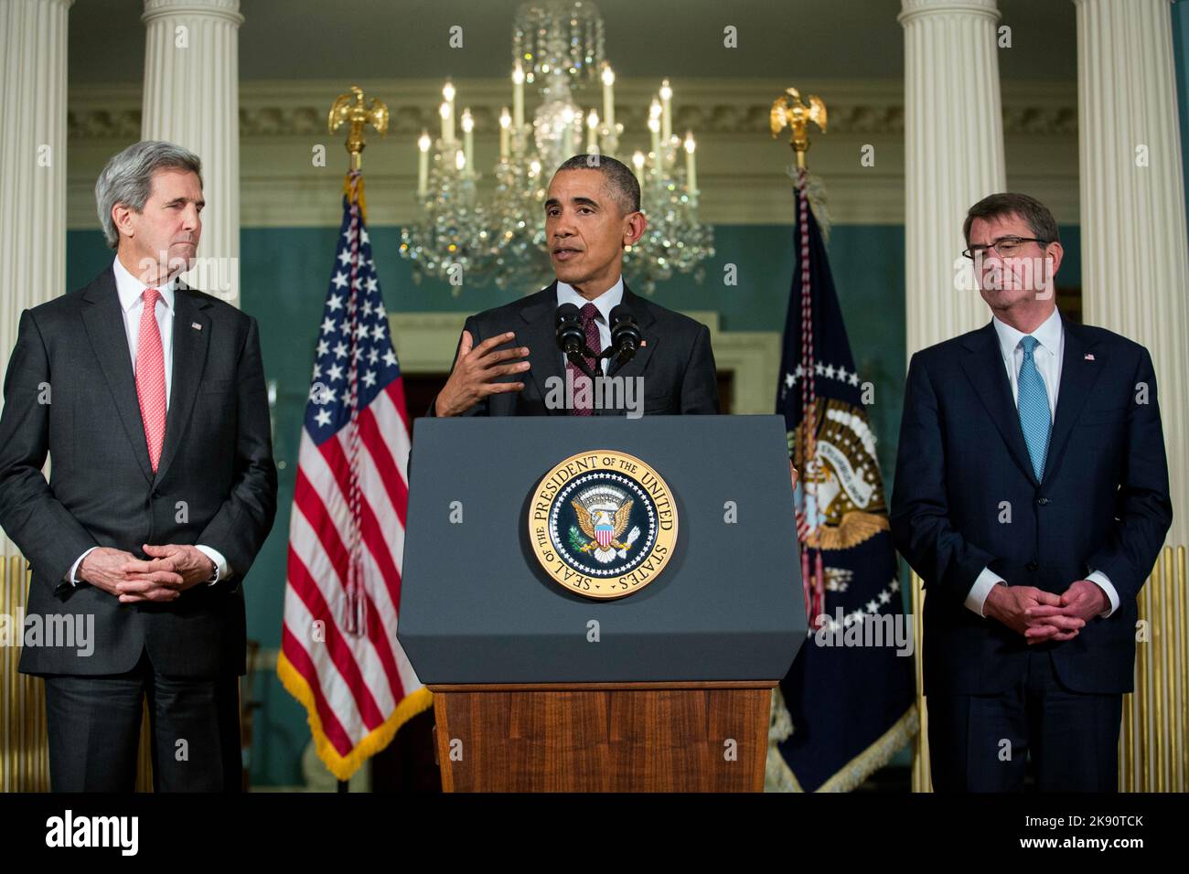 Washington, DC. 25th Feb, 2016. Flanked by United States Secretary of State John Kerry, left, and US Secretary of Defense Ashton Carter, right, US President Barack Obama, center, makes a statement after meeting with his National Security Council at the State Department, February 25, 2016 in Washington, DC. The meeting focused on the situation with ISIS and Syria, along with other regional issues. Credit: Drew Angerer/Pool via CNP/dpa/Alamy Live News Stock Photo