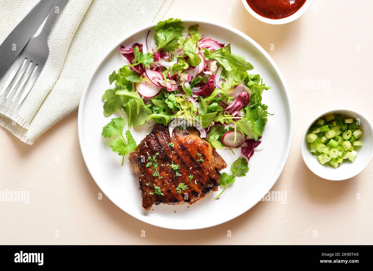 roasted-pork-steak-with-salad-from-fresh-vegetables-over-light-stone