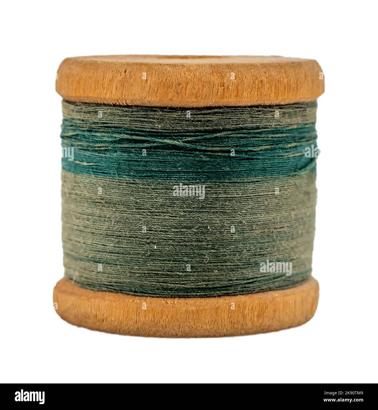 Old wooden spool of thread on a white background closeup. Threads for