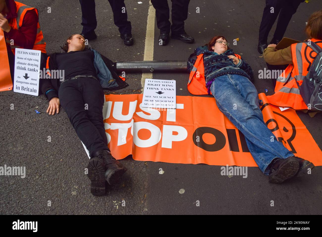 London, UK. 25th October 2022. Just Stop Oil activists sprayed 55 Tufton St with orange paint, and glued and attached themselves to metal pipes on Horseferry Road nearby. The building houses right-wing so-called “think-tanks” and fossil fuel lobbyists. Credit: Vuk Valcic/Alamy Live News Stock Photo