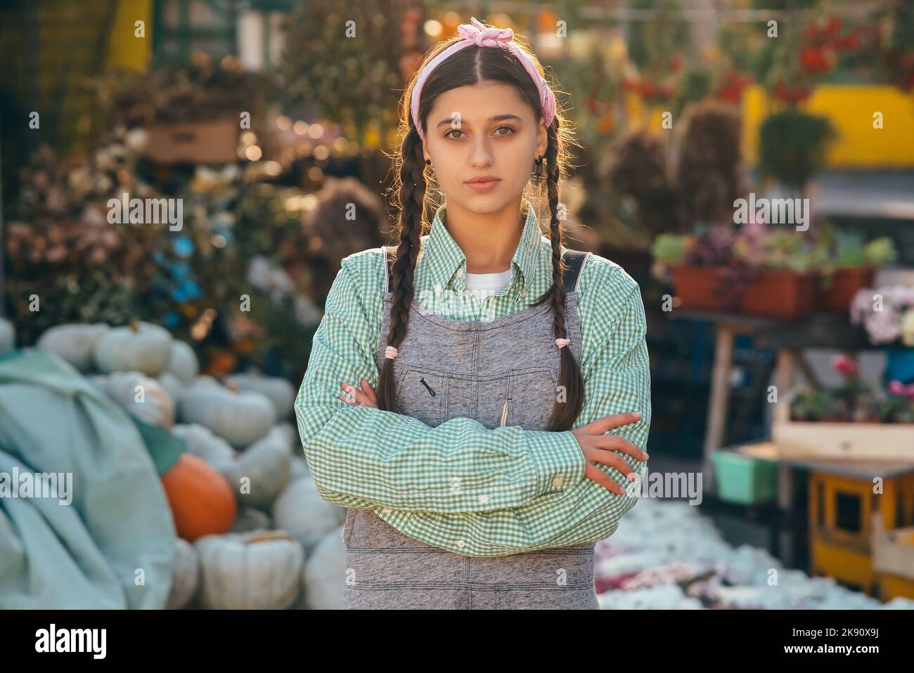 Farmer female poses for the camera in front of the counter. Stock Photo