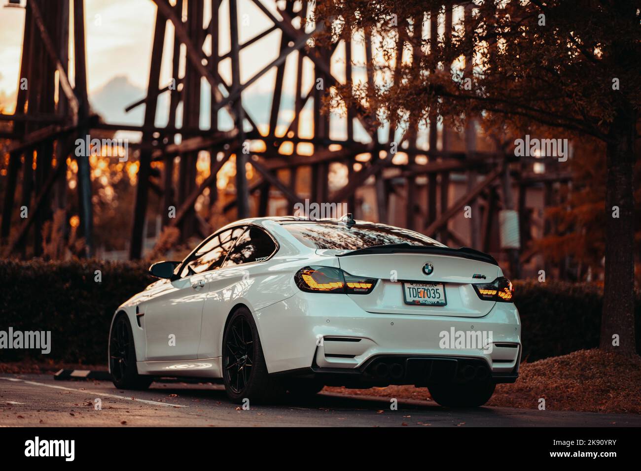 A white BMW M4 parked in front of a bridge Stock Photo - Alamy