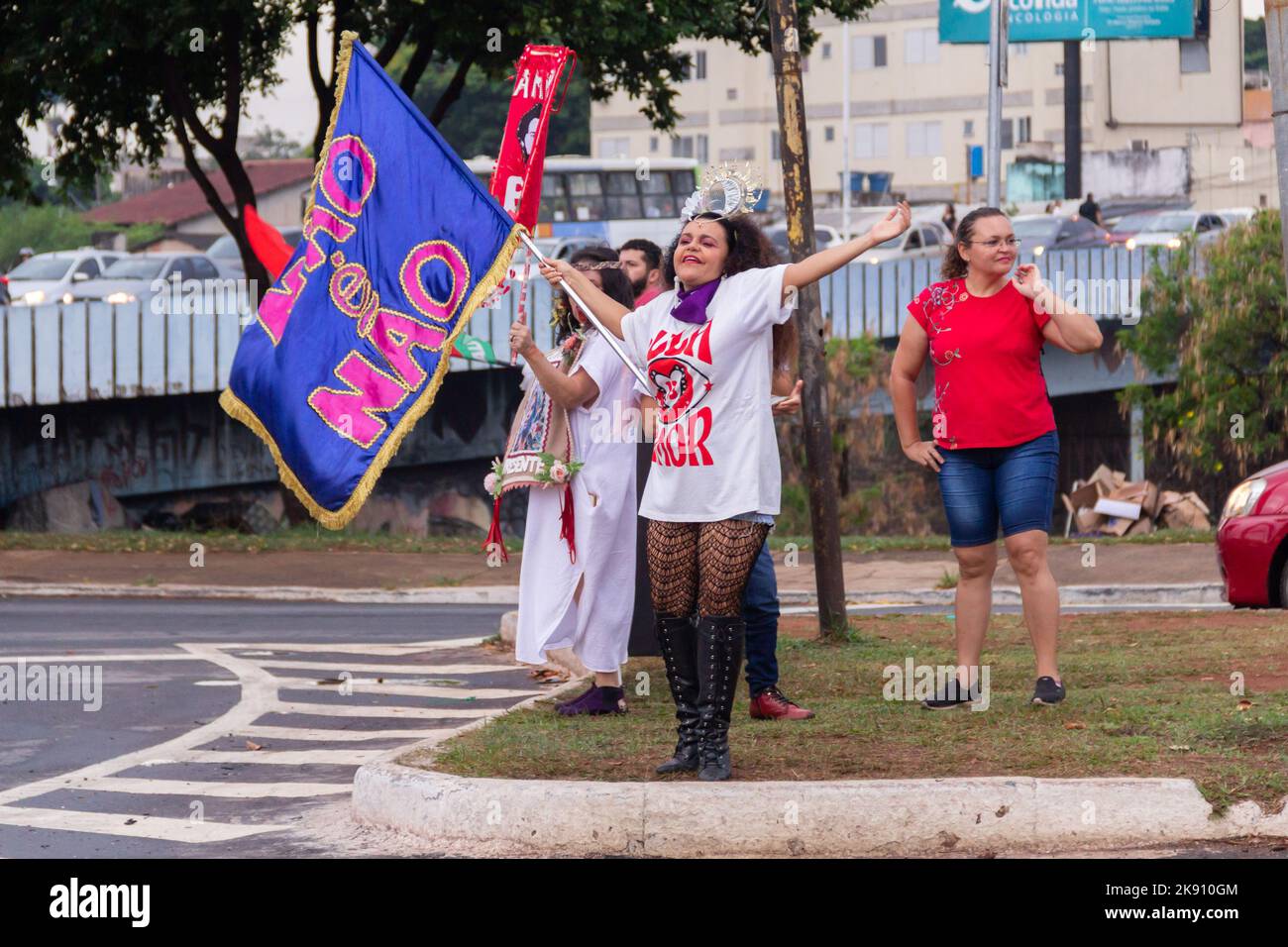 Goiânia, Goias, Brazil – October 21, 2022:  A woman holding a flag and wearing a T-shirt with the text: Lula - 13 - love. Stock Photo