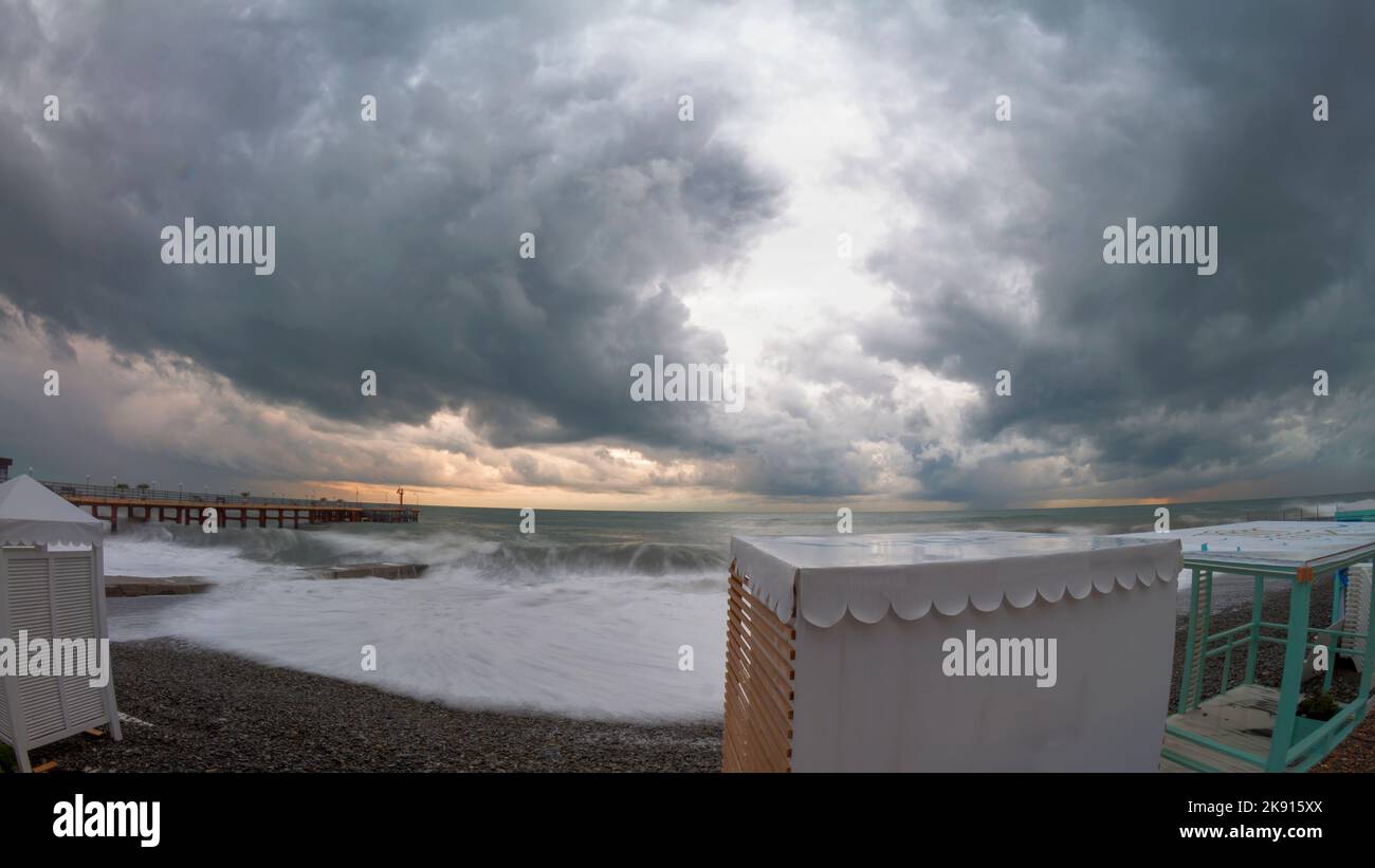 Sochi, Russia - June 5, 2021: The embankment of the Black sea near the city of Sochi Adler after the storm. Structures are destroyed, overturned. Heav Stock Photo
