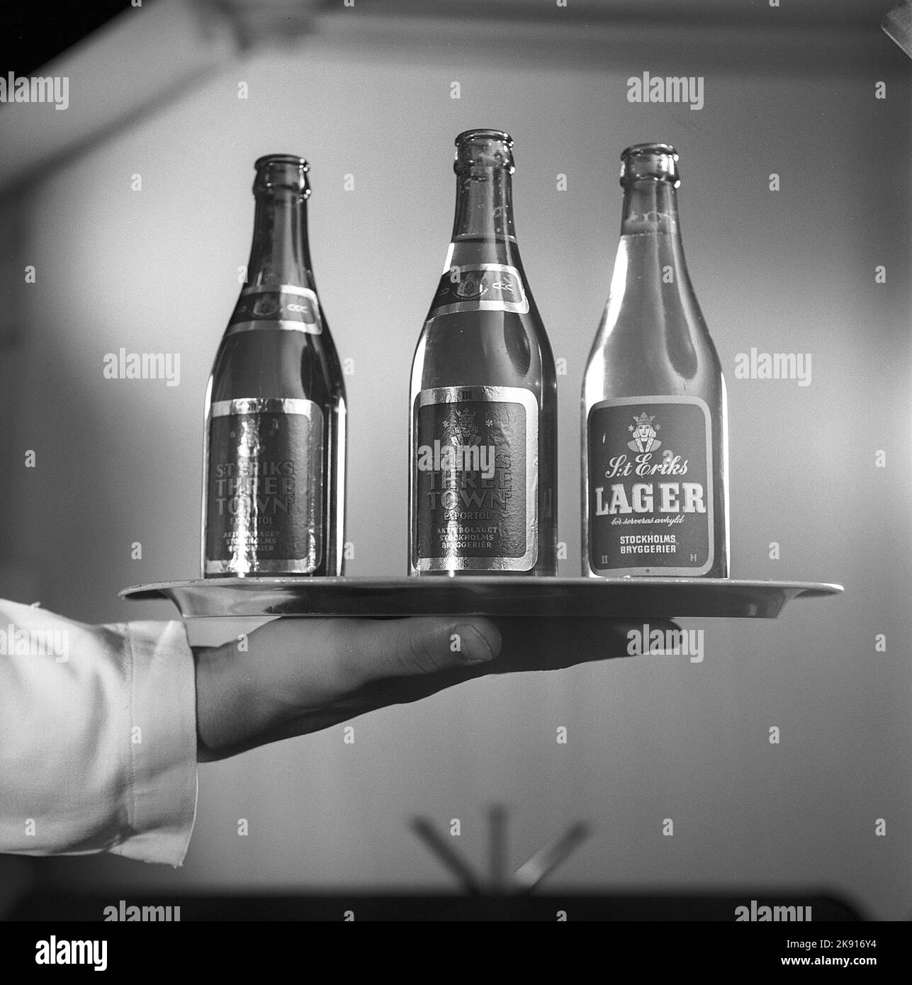 In the 1950s. A waitress holding a tray with three beer bottles on it. Sweden 1959