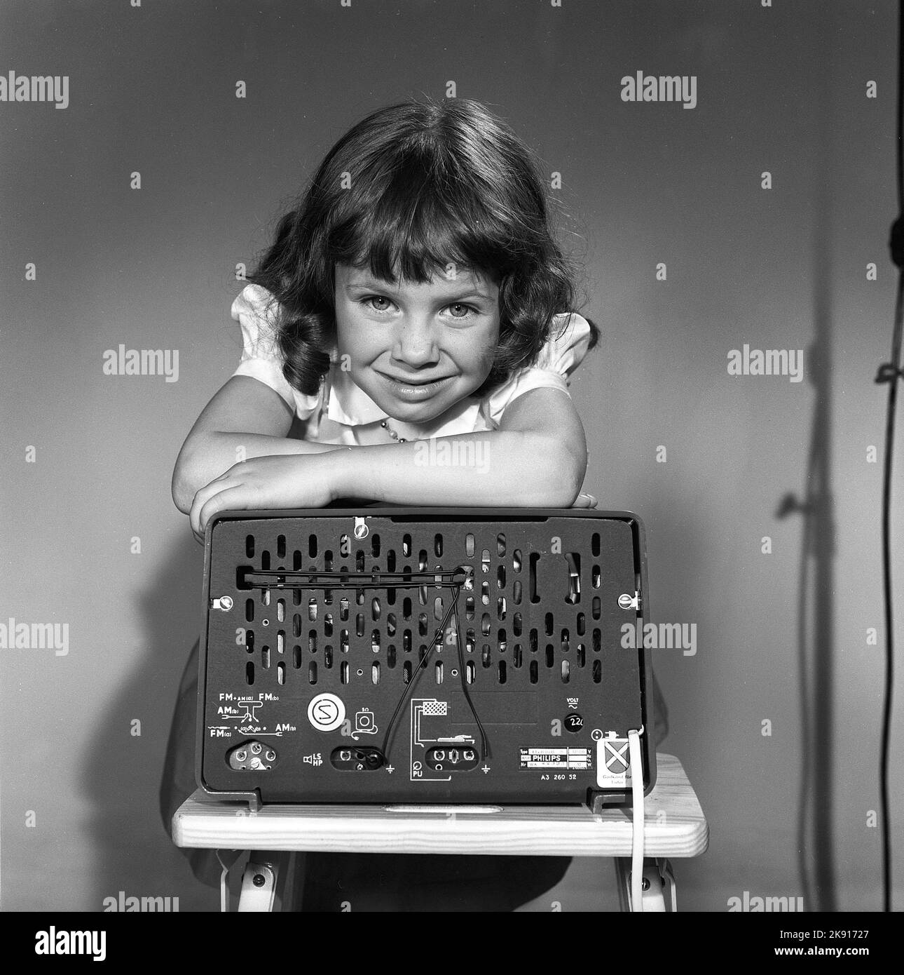 In the 1950s. A girl with a Philips radio set with the backside of the radio visible where the sockets for external antennas are placed.  Sweden 1959. Kristoffersson ref CG70-12 Stock Photo