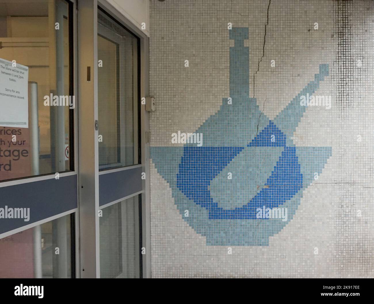 Boots Chemists doorway, Chepstow. Mosaic of a pestle and mortar Sixties