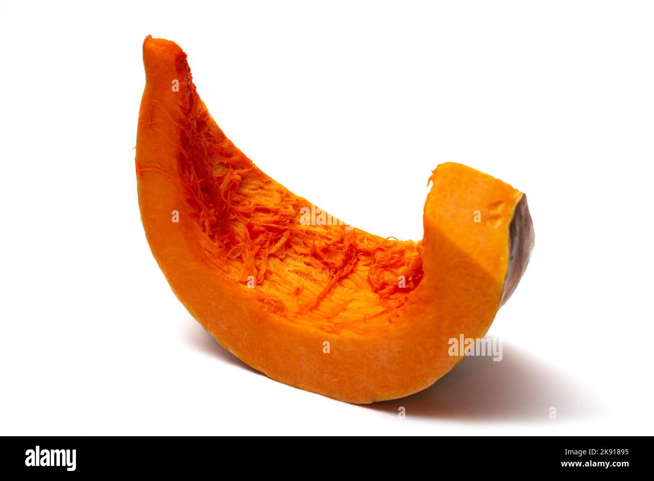 A slice of ripe pumpkin on a white background Stock Photo - Alamy