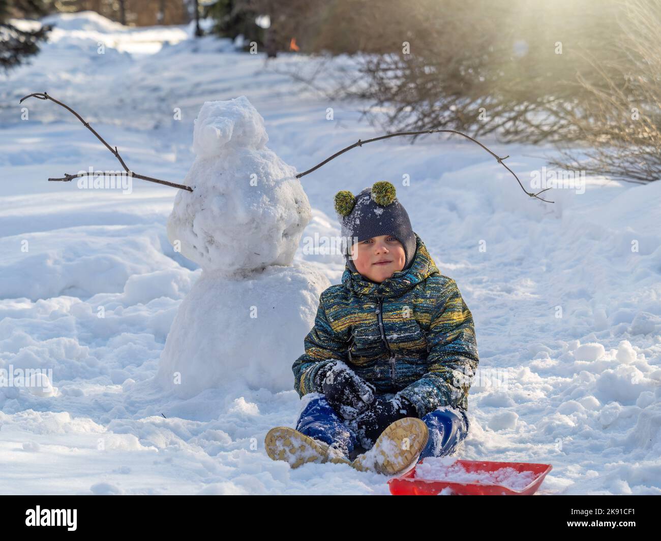 Happy baby boy playing in the snow. Little boy having fun in the snow ...