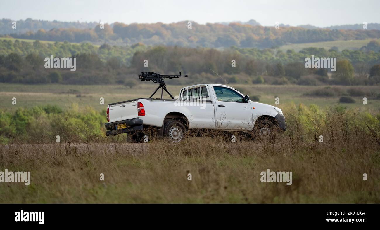 white toyota hilux pickup truck converted with an army large calibre
