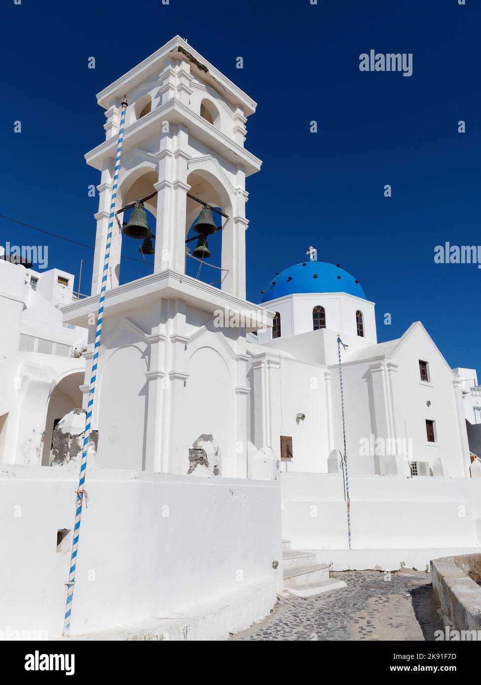 Traditional blue domed church in the town of Imerovigli on the Greek Cyclades island of Santorini in the Aegean Sea Stock Photo