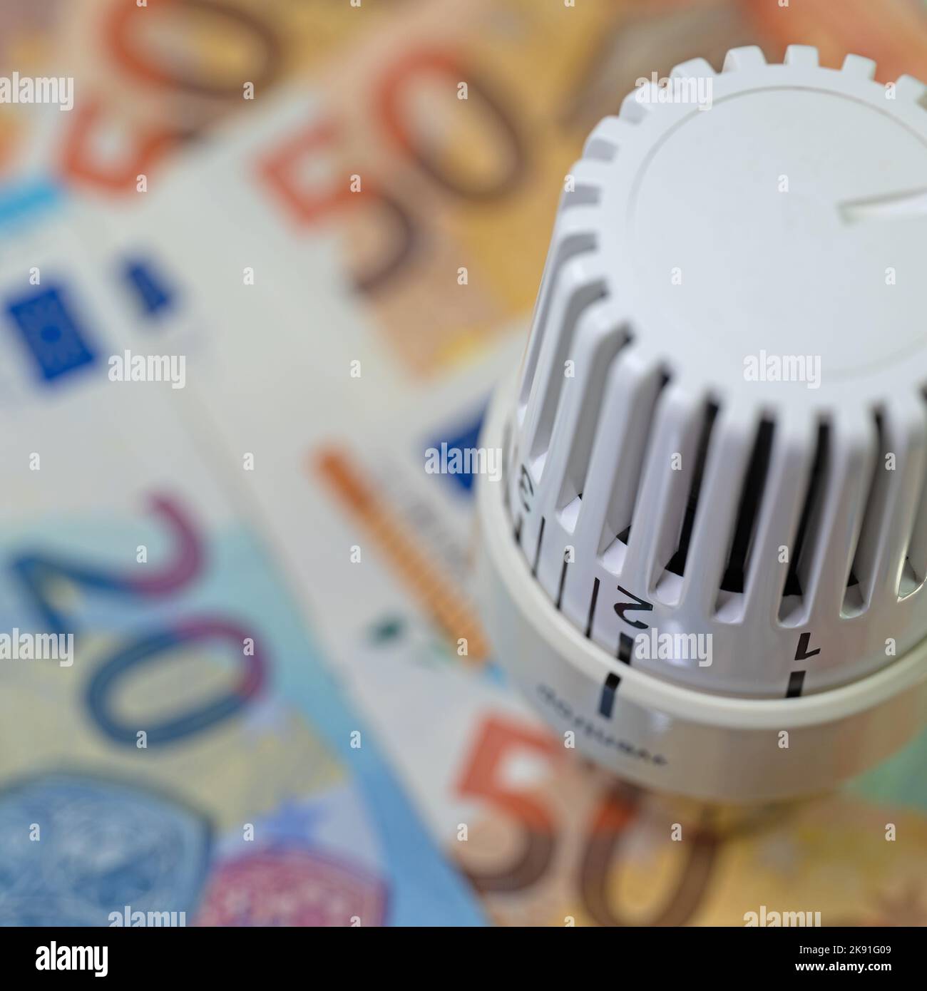 Thermostat in front of banknotes, symbolic of heating costs Stock Photo