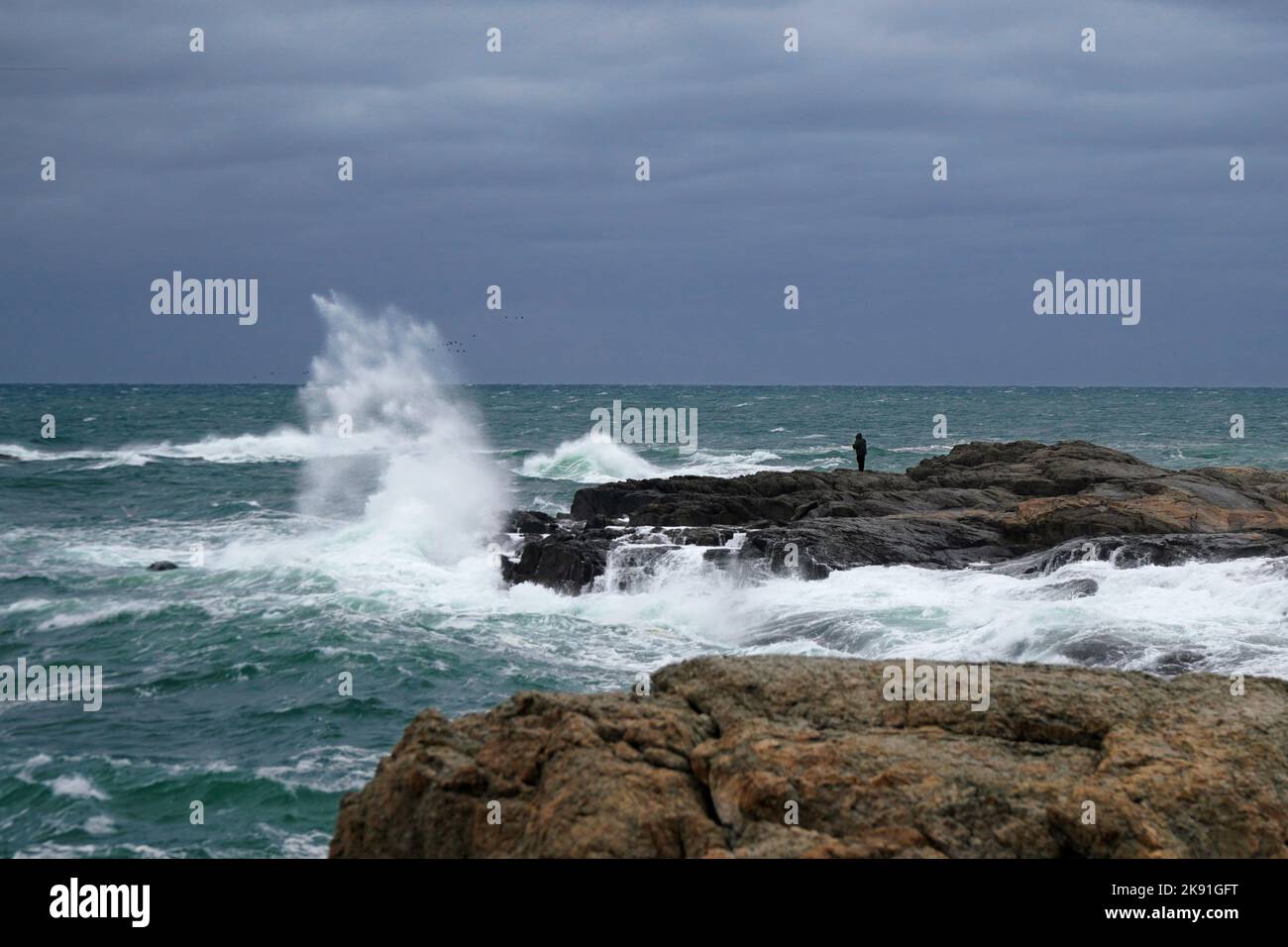 Waves crashing on the rocks along the shore Stock Photo