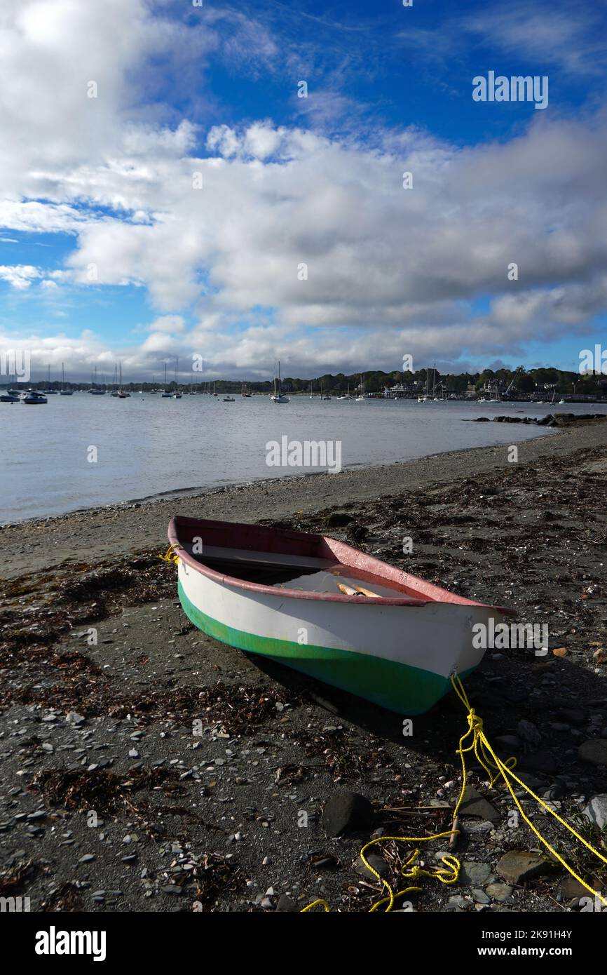 Water-filled row boat beached on shore Stock Photo