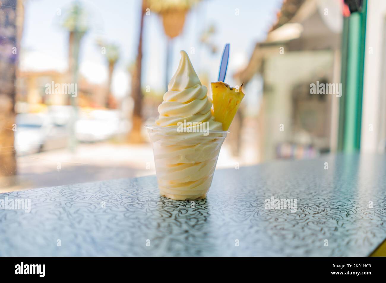 A pineapple dole whip frozen yogurt icecream with a pineapple wedge on