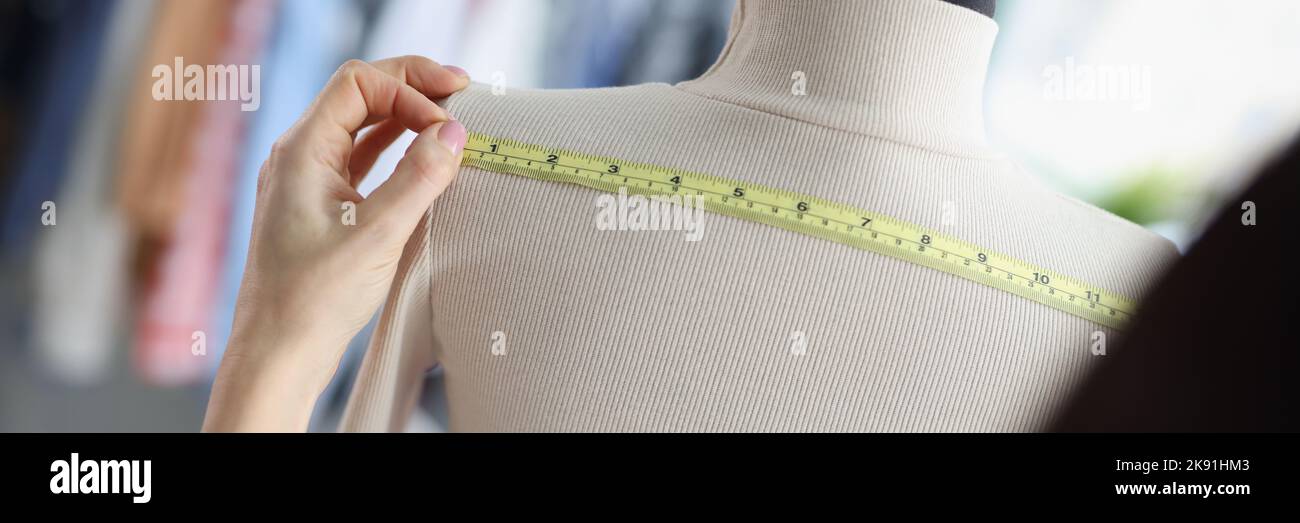 Woman dressmaker measuring on mannequin back for further sewing Stock ...