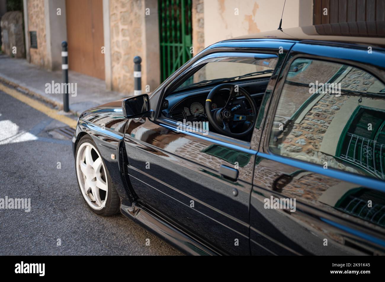 A vintage black Ford Escort RS Cosworth MK5 rally sports car parked on the street in Soller, Spain Stock Photo