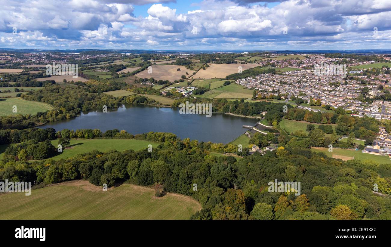 Aerial drone photo of the large Worsbrough reservoir in the village of Worsbrough, Barnsley in Sheffield in the UK, showing the British village and ho Stock Photo