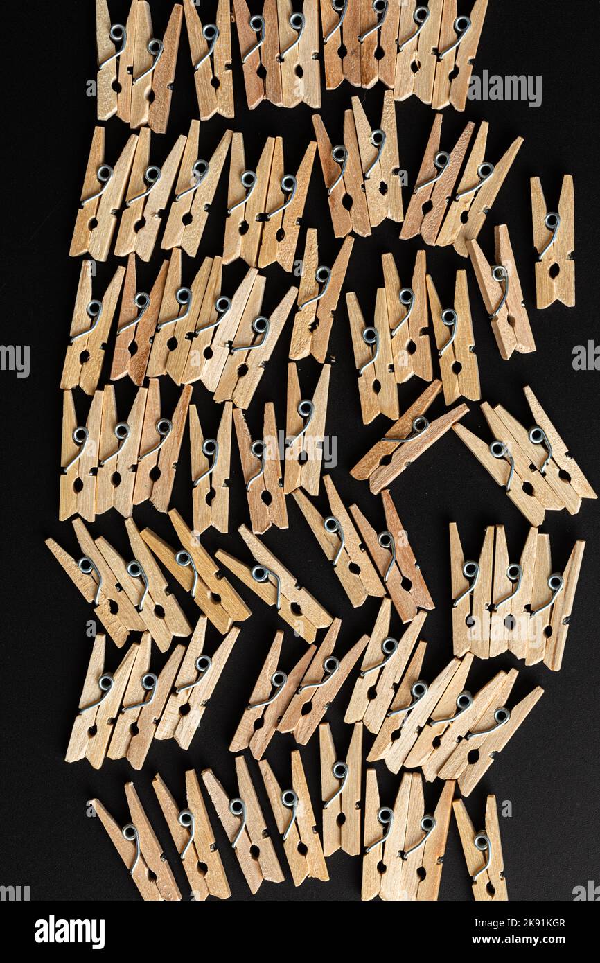 top view of a clothespins in row on dark background Stock Photo
