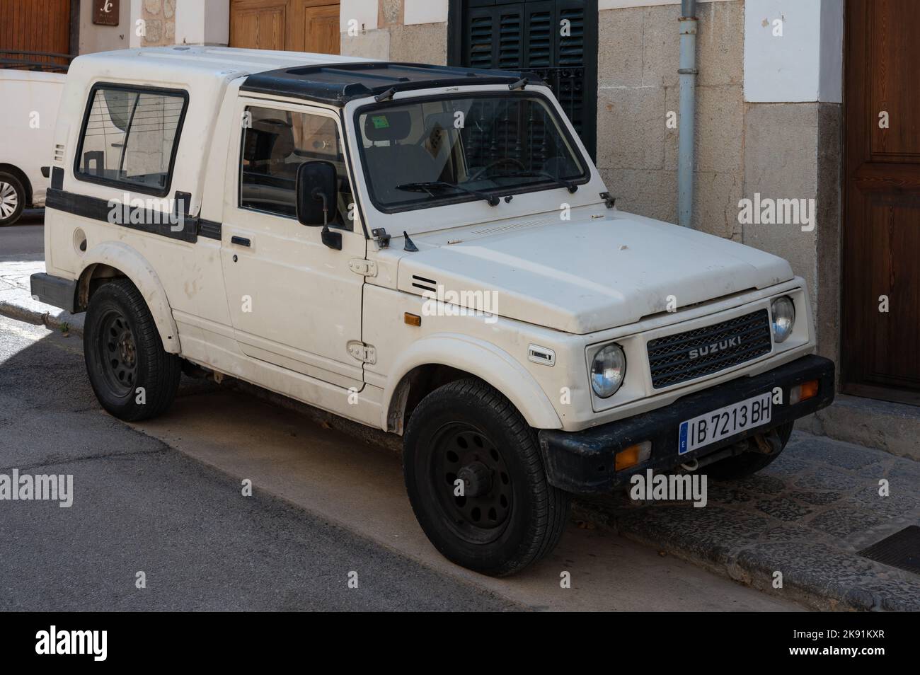 An old white Suzuki Samurai SUV parked on the street in Soller, Spain